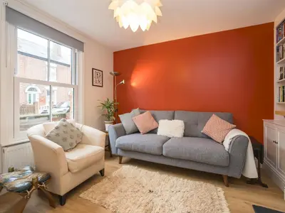a living room with a couch and a chair at Colourful homely 2 bed terrace - Pass the Keys in Shrewsbury