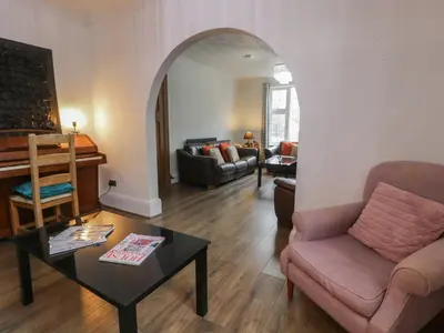 a living room with a couch and a table at Tan Y Fron in Dyffryn
