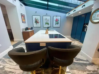 a bathroom with a sink and two bar stools at Stunning fully refurbished house in New Quay