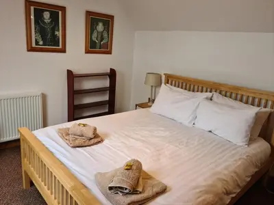 a bedroom with a bed with towels on it at Character cottage with spectacular views in Church Stoke