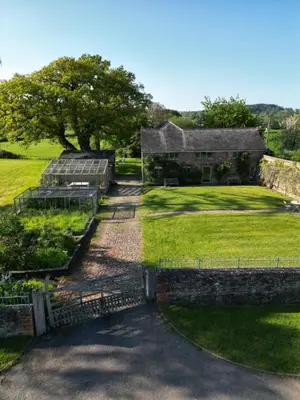 an aerial view of the farmhouse and the garden at River Cottage by Birch Stays in Glasbury