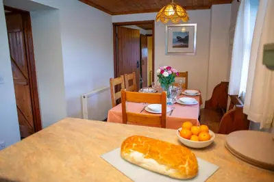 a table with a loaf of bread and a bowl of oranges at Tan-yr-Onnen Llangrannog in New Quay