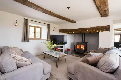 a living room with two couches and a fireplace at Welsh Border Escape- Perfect for families & groups in Clyro
