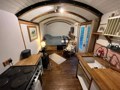 a kitchen and living room in a tiny house at The carriage in Three Cocks Junction