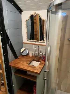 a bathroom with a sink and a shower at the railway carraige in Three Cocks Junction