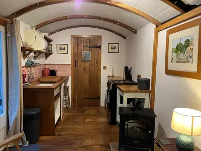 a kitchen with an archway and a stove in a room at the railway carraige in Three Cocks Junction