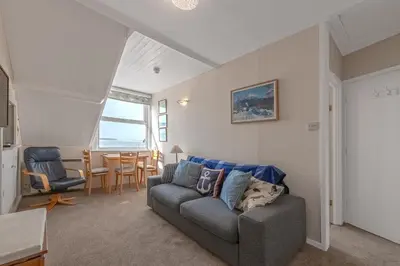 a living room with a couch and a table at Beach Front flat in Aberdovey in Aberdyfi