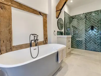 a bathroom with a large tub and a shower at The Farmhouse - Uk48653 in Church Stretton
