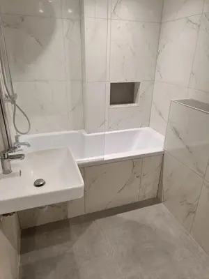 a white bathroom with a tub and a sink at The House of Gnarrr in Machynlleth