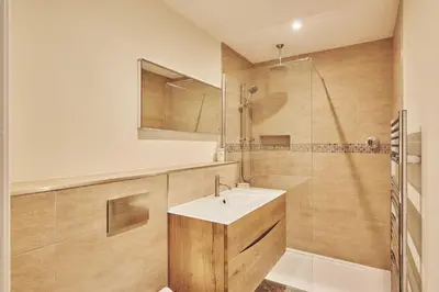 a bathroom with a sink and a shower at Upper Tumble Cottage in Montgomery