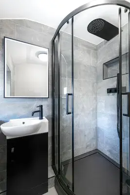 a bathroom with a sink and a shower at Cosy 3 bedroom cottage by the sea in Aberdovey in Aberdyfi