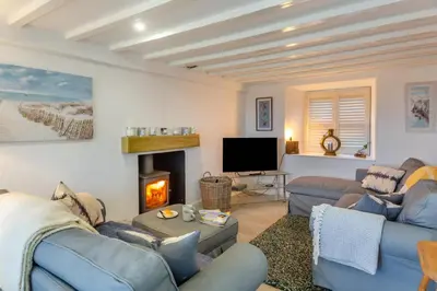 a living room with two blue couches and a fireplace at 2 Bed in Llanfair oc-a30451 in Llanfair