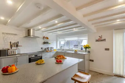 a kitchen with a large island with fruits on it at 2 Bed in Llanfair oc-a30451 in Llanfair