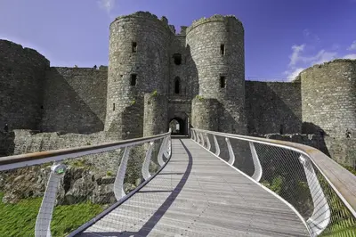 a bridge in front of a castle with a building at 2 Bed in Llanfair oc-a30451 in Llanfair