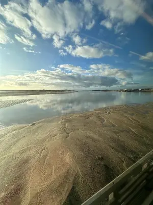 a body of water with the sky and clouds at Little Cottage, Llwyngwril in Llwyngwril