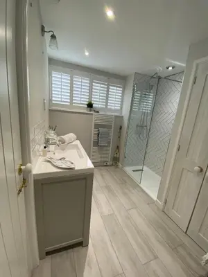 a bathroom with a sink and a shower at Nant Llys - Spectacularly placed with sea views in New Quay