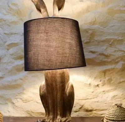 a wooden lamp sitting on top of a table at Glovers cottage private hot tub and super king in Llanrhystyd