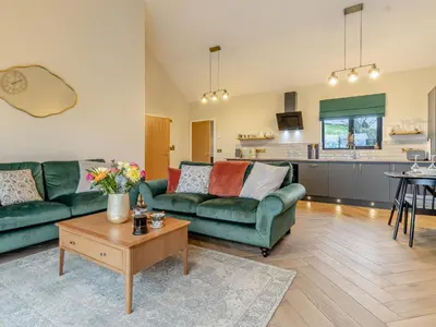 a living room with two green couches and a table at Root - Uk47733 in Mochdre