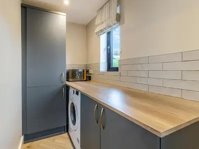 a kitchen with a counter top and a refrigerator at Root - Uk47733 in Mochdre
