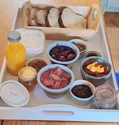 a lunch box with bread and different types of food at Bryn Teg Barn in Dyffryn