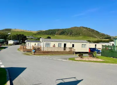 a house on the side of a road at Gold Standard Luxury and Modern Static Caravan at Clarach Bay in Aberystwyth