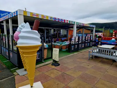 an ice cream cone sitting in front of a store at Gold Standard Luxury and Modern Static Caravan at Clarach Bay in Aberystwyth