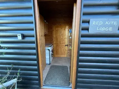 a door to a pod kite lodge with a sign on it at Red Kite Lodge in Clyro