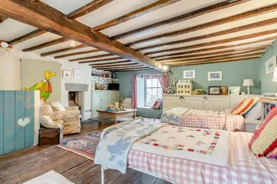 a bedroom with two beds and a living room at 6 Bed in Llanfilo oc-e30630 in Llandefalle
