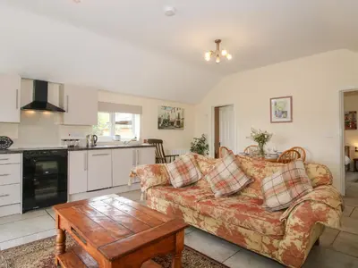 a living room with a couch and a table at Millstone Cottages - Millstone Cottage in Shrewsbury