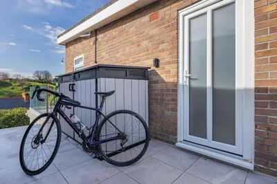 a bike parked next to a brick building at 2 Bed in Aberdovey oc-n30627 in Aberdyfi