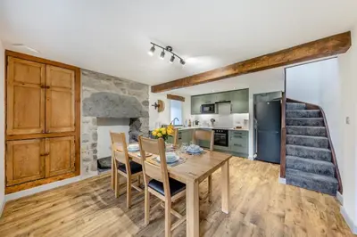 a kitchen and dining room with a table and chairs at 2 Bed in Penmaenpool oc-m30050 in Arthog
