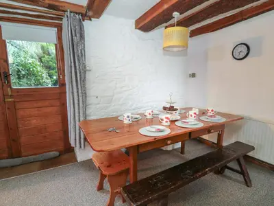 a wooden table with dishes on it in a room at Ty Ceffylau in Llanybydder