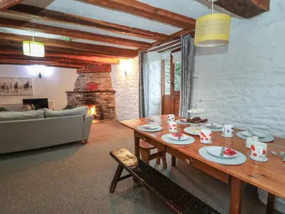 a living room with a wooden table and a couch at Ty Ceffylau in Llanybydder