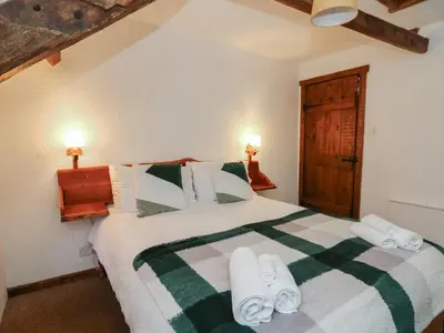 a bedroom with a bed with towels on it at Ty Ceffylau in Llanybydder