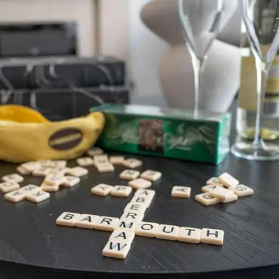 a table with a banana and a box of abc blocks and a banana sidx at Barmouth High Street Family Apartment in Barmouth
