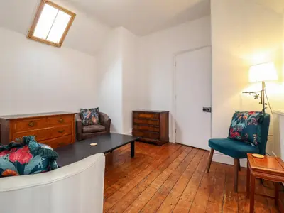 a living room with a couch and a table at The Courtyard Cottage in Llangollen