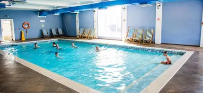 a group of children swimming in a swimming pool at 2 Bed Caravan - Sleeps 4 - Pets - Parking - Wifi in Aberystwyth