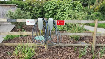 a garden with a fence with at Swn Y Nant Lodge with hot tub Brecon in Brecon