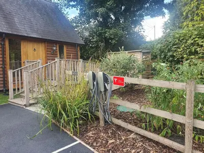 a fence with a pair of pay phones in front of a house at Swn Y Nant Lodge with hot tub Brecon in Brecon