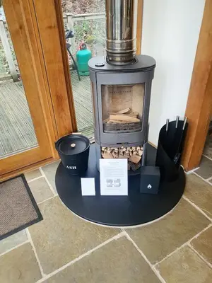 a stove sitting on a table in a room at Swn Y Nant Lodge with hot tub Brecon in Brecon