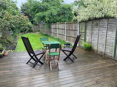 a patio with a table and chairs on a deck at Little Hotspur in Shrewsbury