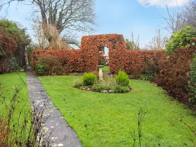 a garden with a building made out of brick at Hafanedd in Dyffryn