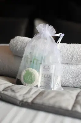 a plastic bag with a cup and some towels at OYO Glyn Valley Hotel in Glyn-Ceiriog