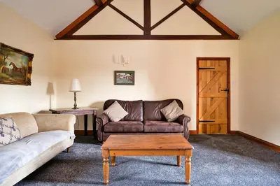 a living room with a couch and a table at Finest Retreats - Walton Maisonette in Onibury