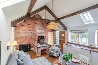 a kitchen and living room with a brick fireplace at 2 Bed in Llangedwyn oc-l30530 in Llangedwyn