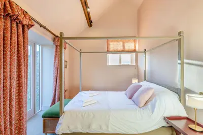 a bedroom with a canopy bed and a window at 2 Bed in Llangedwyn oc-l30530 in Llangedwyn