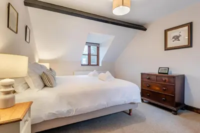 a bedroom with a white bed and a wooden dresser at 3 Bed in Leominster oc-r30485 in Yarpole