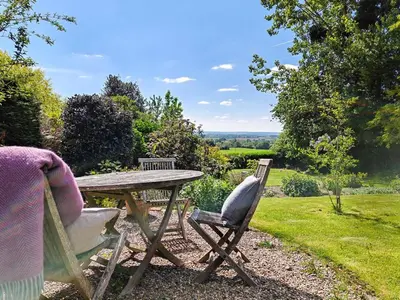 a picnic table and chairs with a view of a field at 3 Bed in Leominster oc-r30485 in Yarpole