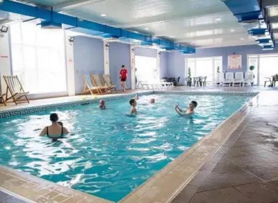 a group of people in a swimming pool at Pet Friendly 3 Bed Static Caravan in Clarach Bay Spacious and Cozy Stay in Aberystwyth