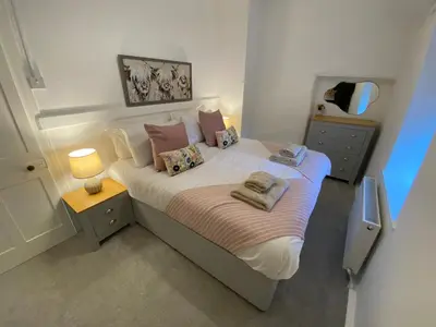 a bedroom with a large bed with two towels on it at Golygfa'r Orsaf Snowdonia national park, Bala lake in Bala